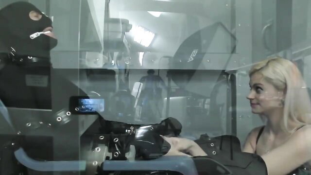 Blonde sub in lingerie kneels for masked dom in BDSM studio scene