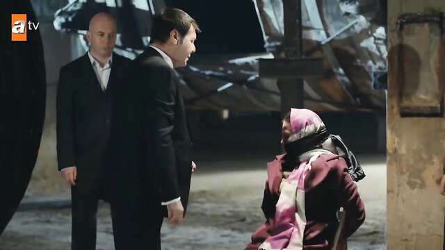 Hijab woman gagged and bound in BDSM scene with suited men