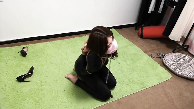 Chinese woman in black latex suit bound kneeling BDSM bondage