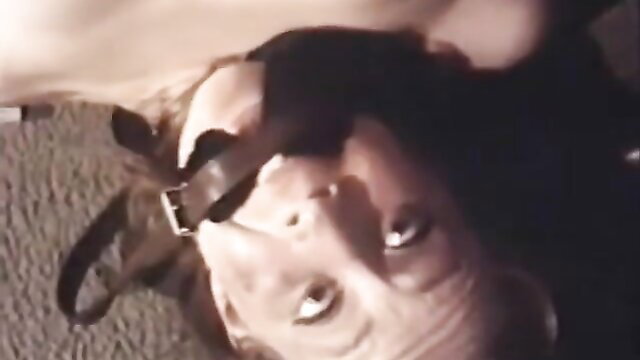 Vintage 1973 BDSM bondage: slavegirl gagged in harness, upside down submission