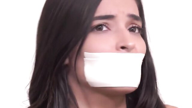 Emily gagged & hogtied barefoot, struggling in tight BDSM bondage