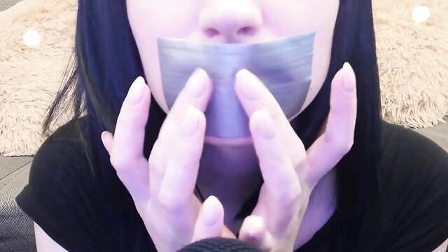 Asian girl with black hair gagged in duct tape ASMR BDSM closeup