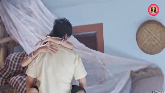 Indian couple intense embrace, man hugging woman from behind in bed