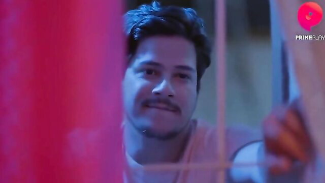 Handsome Indian man peeking through red bars in hot Juaa S01E02 Primeplay web series