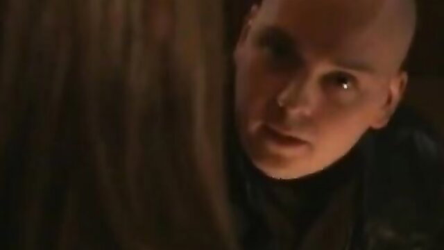 Bald mature dom man leers at brunette damsel in intense BDSM scene