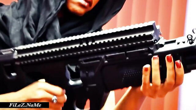 Veiled woman gripping huge black rifle in terrorist BDSM XXX teaser
