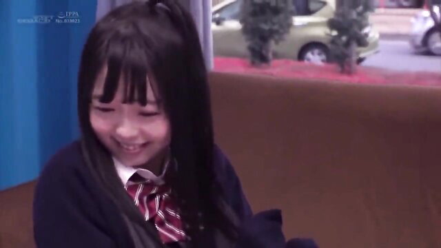 Cute Asian teen in school uniform smiling on couch, JAV BDSM tease