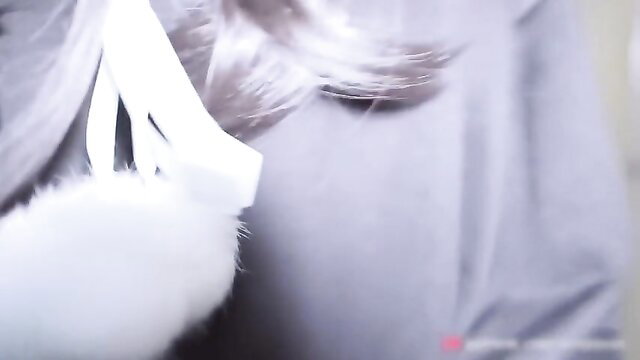 Hot transvestite in white fur & ribbon mask, teasing closeup