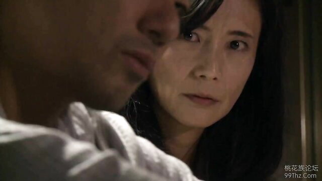 Closeup of Asian mature wife with intense gaze in JAV scene