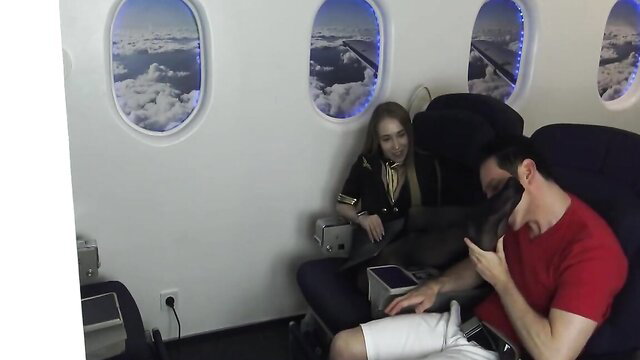 Blonde stewardess makes man sniff and lick her bare feet in airplane seat BDSM