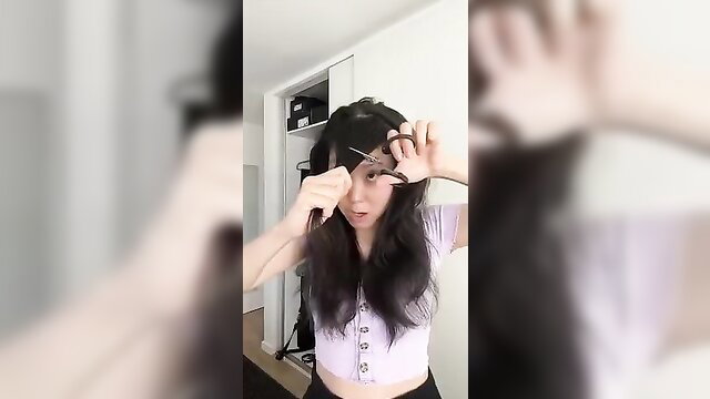 Asian beauty impulsively cutting bangs in tight top, solo amateur tease