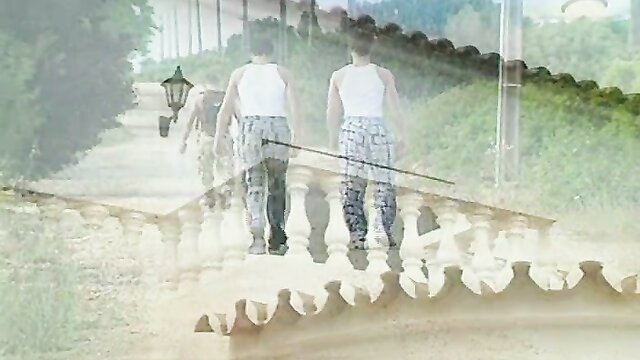 Two beautiful young boys walking in loose pants on outdoor path