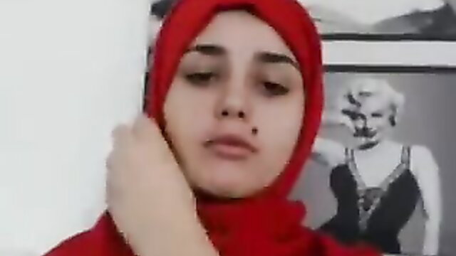 Arab hijab girl in red headscarf closeup, Marilyn Monroe poster background