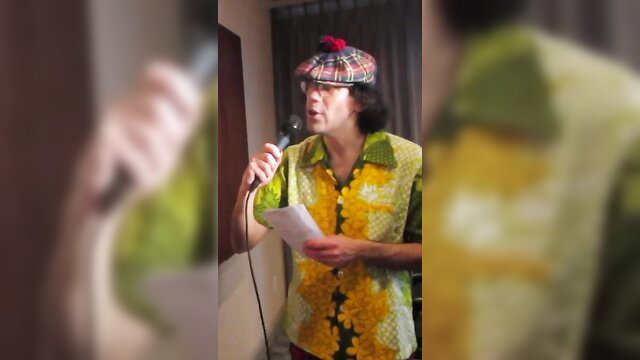 Nardwuar in yellow Hawaiian shirt and tam o'shanter holds mic interviewing Future