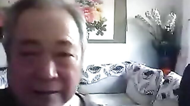 Elderly Asian man smiling on webcam, old couple amateur preview