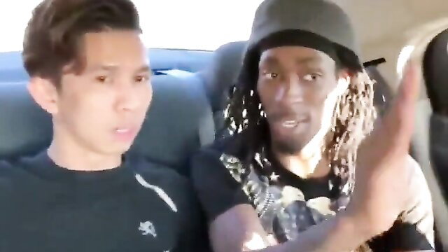 Asian twink and dreadlocked black guy in intense car chat, gay tension