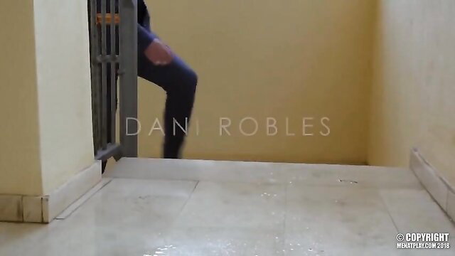 Dani Robles in torn jeans at doorway in hot gay porn scene
