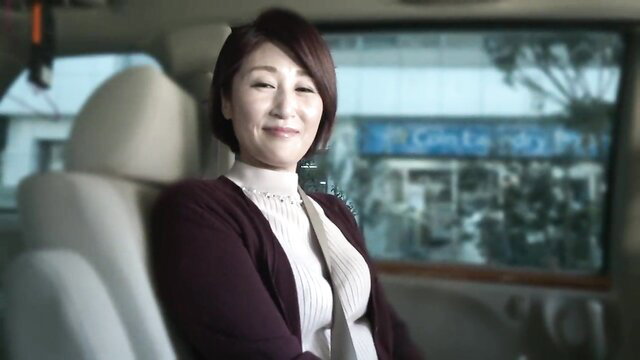 Takahashi Misono mature Japanese wife smiling in car, deep cleavage