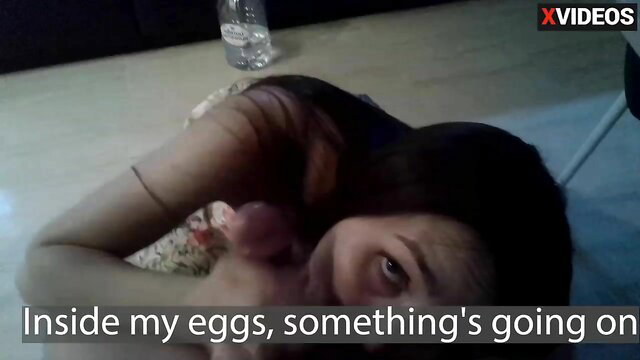 Asian woman lying on floor, holding cock to mouth in amateur JAV scene