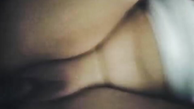 Blurry closeup of curvy blonde's neck and cleavage in adult video
