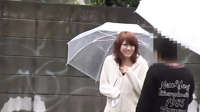 Rumi Fujino in white hoodie and umbrella, rainy JAV amateur tease