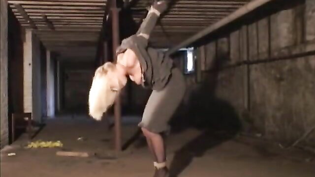 Crystal Frost bound in stockings, bent over in BDSM pose