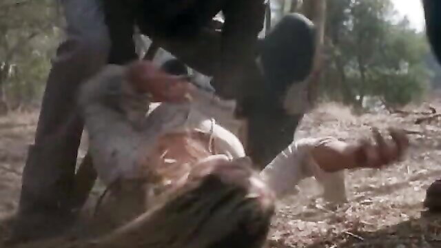 BDSM outdoor struggle: woman in white dress pinned by man in black