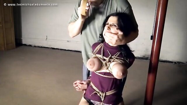 Hannah Perez bound in strict ropes, gagged and exposed tits in BDSM scene