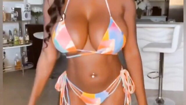 Ellie The Empress black babe in skimpy colorful bikini showing huge tits