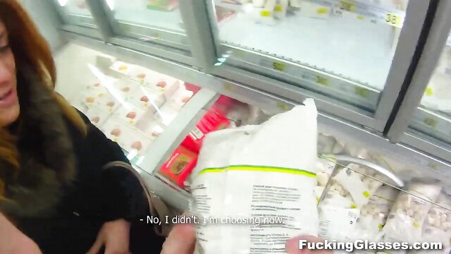 Redhead woman in fur scarf grabs bag from store fridge shelf
