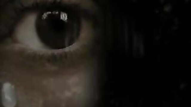 Closeup of woman's intense eye staring in dimly lit adult video thumbnail