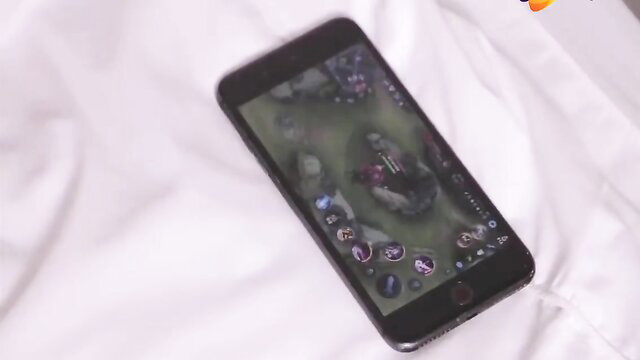 iPhone screen showing Mobile Legends game on white bed, adult teaser thumbnail