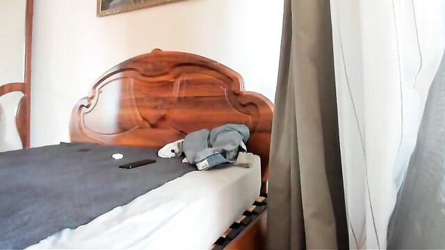 Muscle man cuddles blue plushie on bed in gay cam porn thumbnail