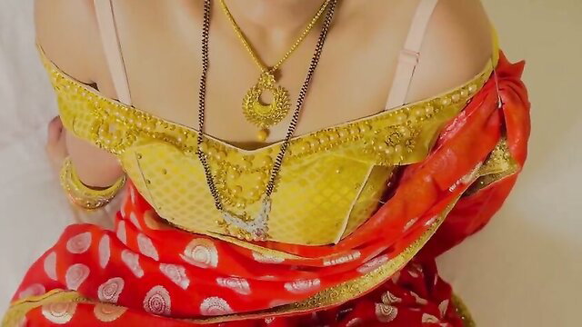 Honey Moon in yellow saree blouse, gold jewelry, Indian wife suhaagraat pose