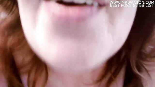 Closeup of smiling redhead woman's open mouth in amateur porn thumbnail