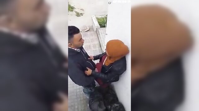 Imen Chiban Gabes Kattana outdoor couple flirt, man grabs woman in hijab leather jacket