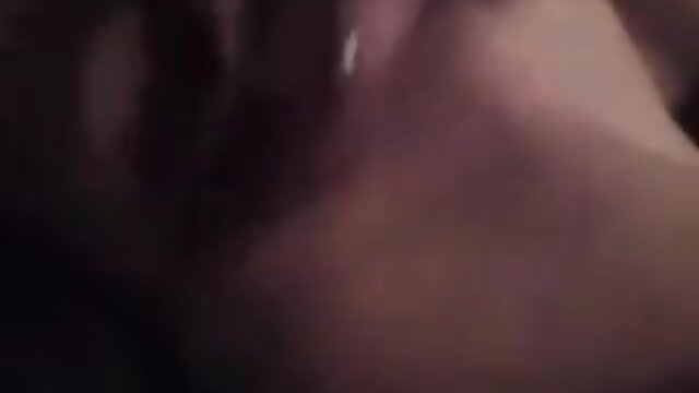 Closeup of woman's glossy lips and tongue in erotic tease