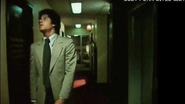 Sharon Mitchell in green suit in 1977 classic Joy hotel hallway