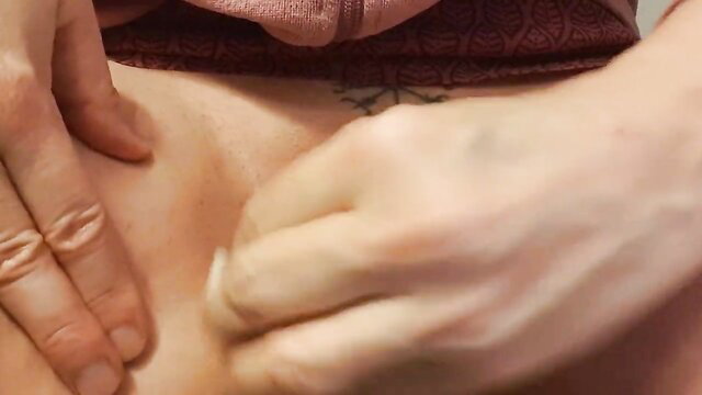 Closeup of woman shaving her smooth pussy with hand spreading lips