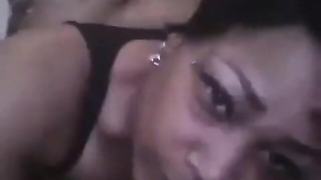 Closeup of sexy black woman's face in dim light, seductive gaze