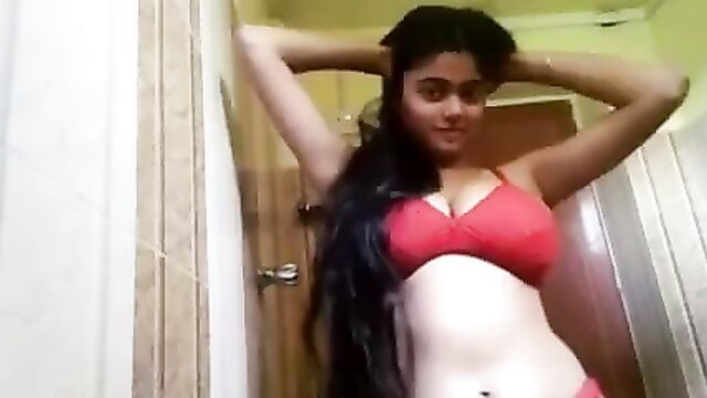 Breasty Indian babe in red bra poses topless in bathroom