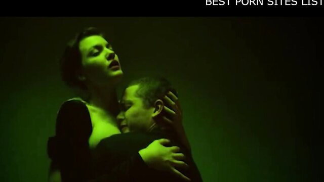 Intense green-lit sex embrace, passionate couple in erotic thriller scene