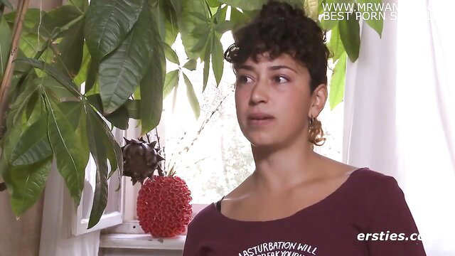 Curly haired brunette in maroon top discusses knowing body and orgasms