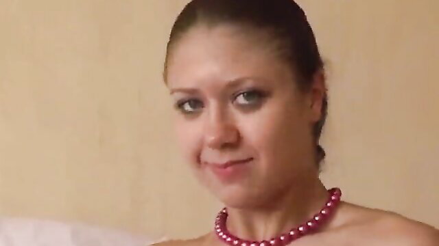 Brunette with pearl necklace smiling closeup in amateur video