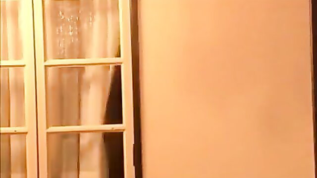 Japanese MILF behind sheer curtains in dimly lit room