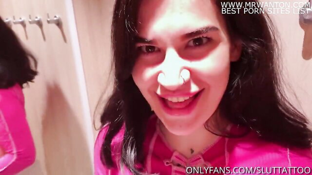 Hot brunette smiling in pink lingerie in dressing room