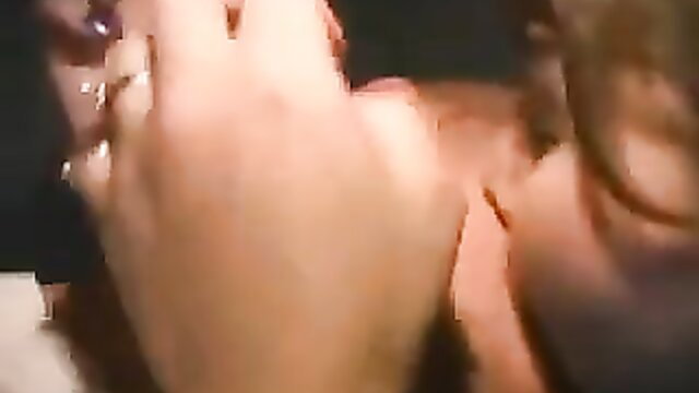 Closeup of woman giving gloryhole blowjob with cum swap kiss