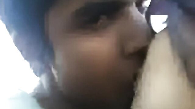 Indian couple kissing passionately on roof, girlfriend in white top