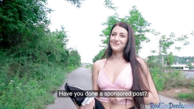 Brunette babe in pink top asks about sponsored post on park path