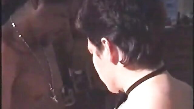 Black man embraces brunette woman in lingerie from behind